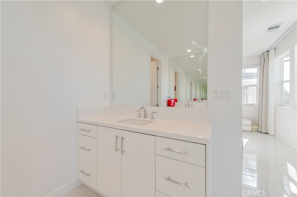 131 Reyes Alley Lake Forest, CA 92630 - Photo 26 of 39 a bathroom with a sink and a mirror