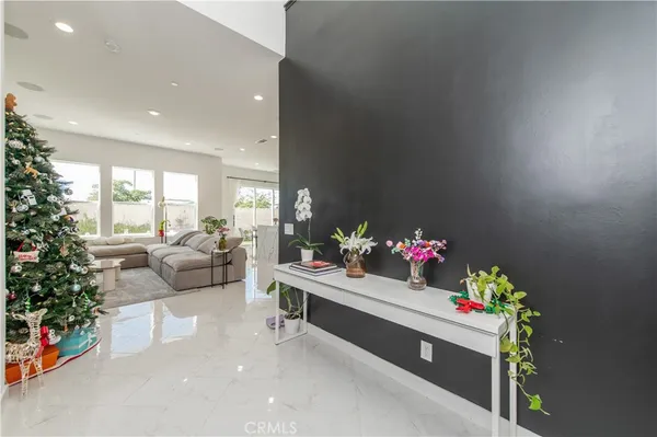 a living room with furniture and flowers