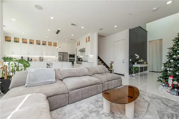 a living room with furniture and kitchen view
