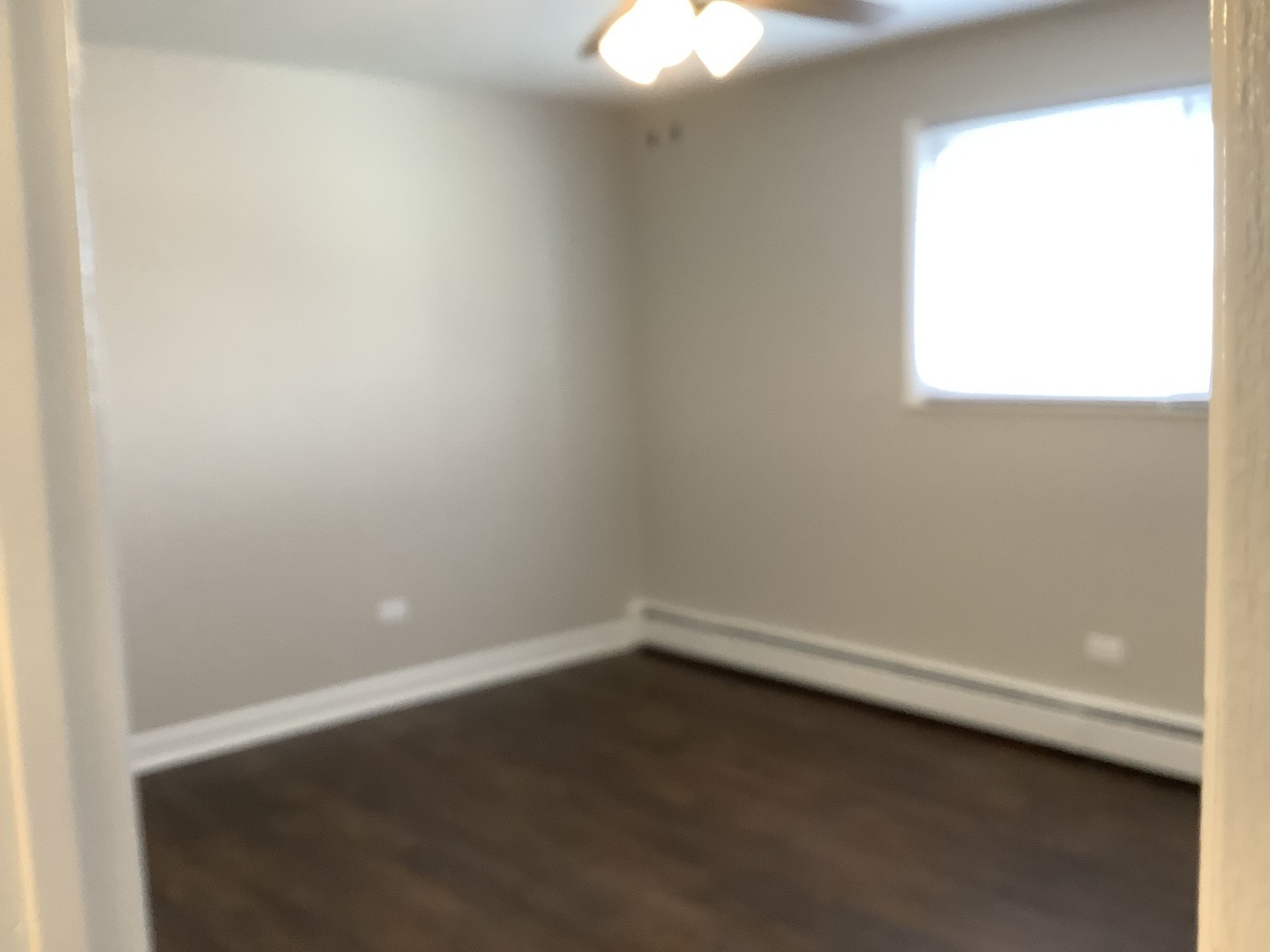 10530 Parkside Avenue, Unit 10 Chicago Ridge, IL 60415 - Photo 17 of 30 an empty room with a window