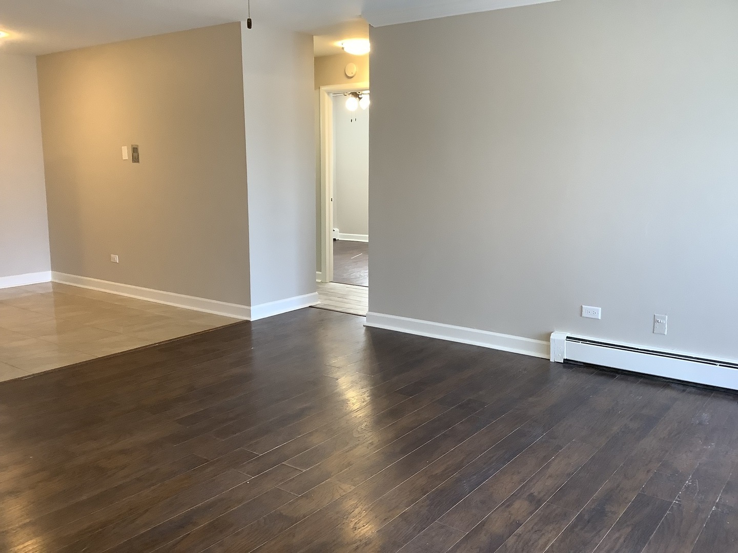 10530 Parkside Avenue, Unit 10 Chicago Ridge, IL 60415 - Photo 18 of 30 an empty room with wooden floor and white walls