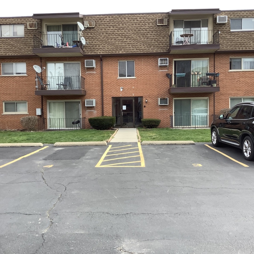 10530 Parkside Avenue, Unit 10 Chicago Ridge, IL 60415 - Photo 27 of 30 a car parked in front of a brick house