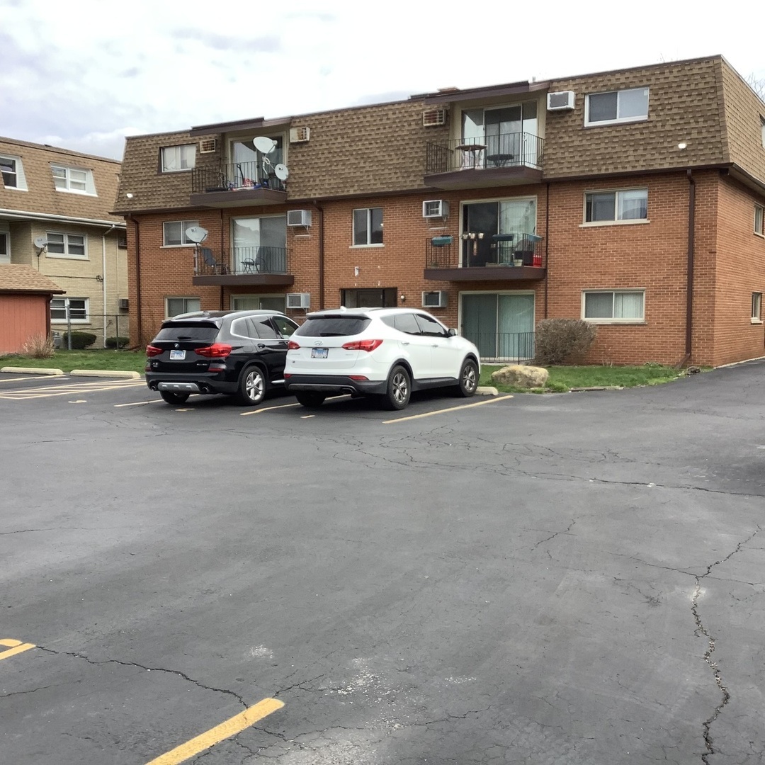 10530 Parkside Avenue, Unit 10 Chicago Ridge, IL 60415 - Photo 28 of 30 a car parked in front of a building