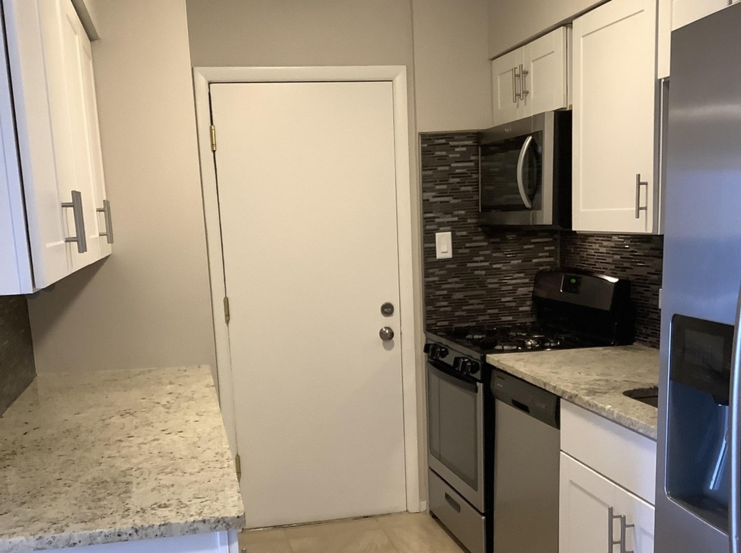 10530 Parkside Avenue, Unit 10 Chicago Ridge, IL 60415 - Photo 5 of 30 a kitchen with a sink stove and refrigerator