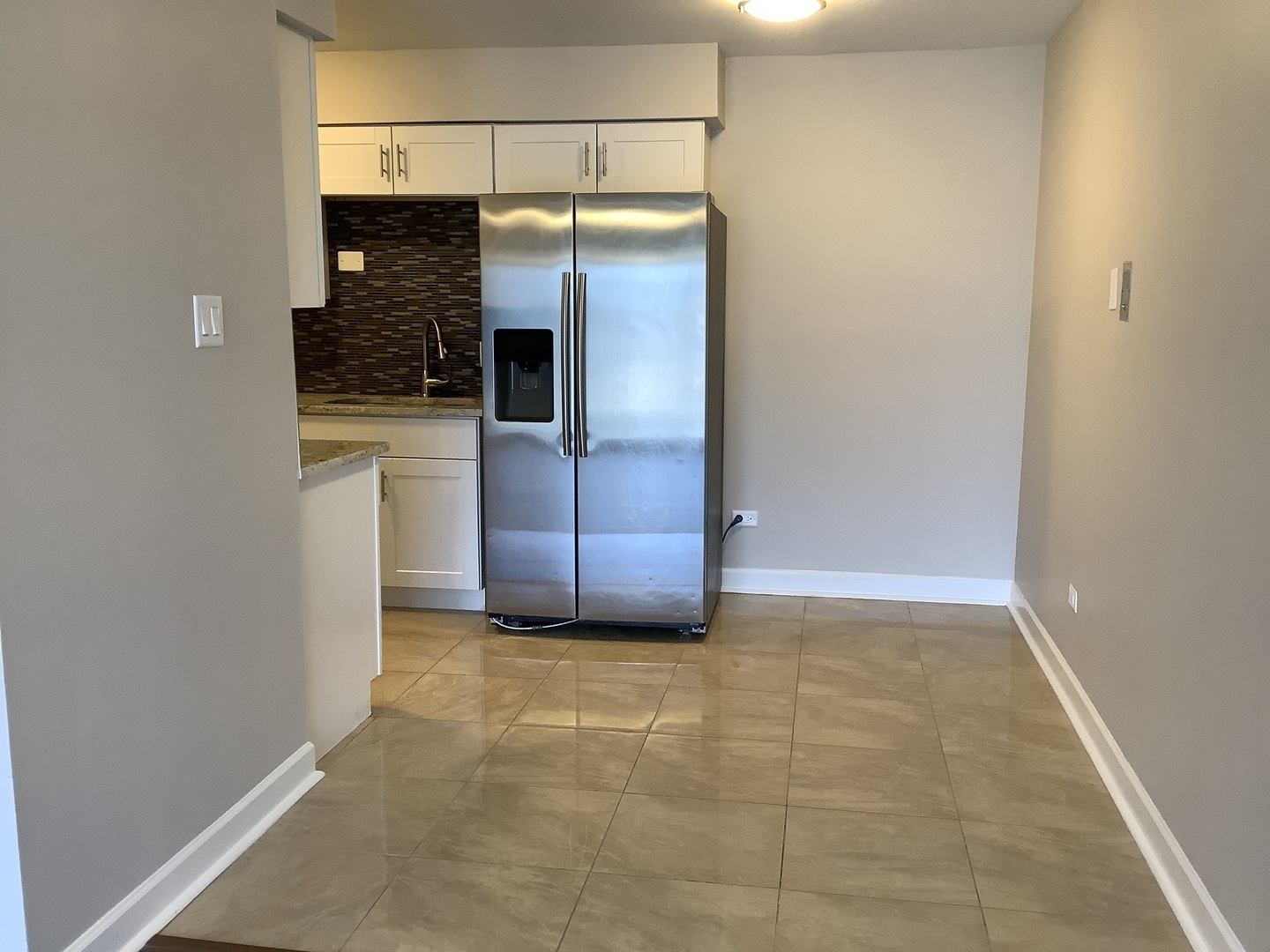 10530 Parkside Avenue, Unit 10 Chicago Ridge, IL 60415 - Photo 6 of 30 a view of a refrigerator in kitchen and an empty room