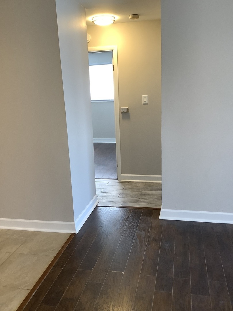 10530 Parkside Avenue, Unit 10 Chicago Ridge, IL 60415 - Photo 7 of 30 an empty room with wooden floor