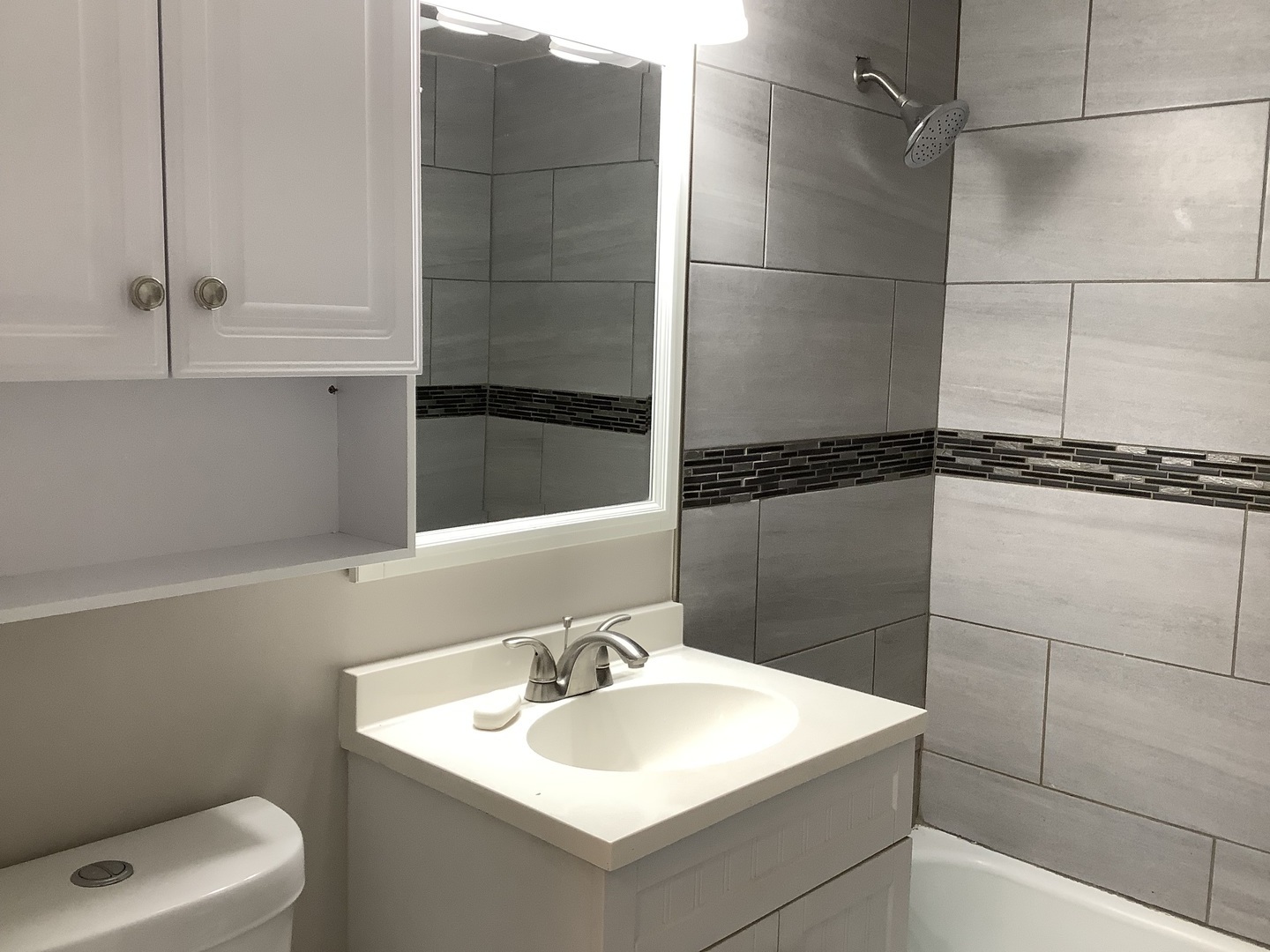 10530 Parkside Avenue, Unit 10 Chicago Ridge, IL 60415 - Photo 9 of 30 a bathroom with a sink and mirror