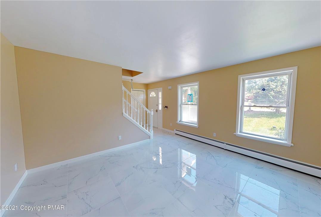 1110 Misty Ridge East Stroudsburg, PA 18302 - Photo 21 of 43 Reflective tile flooring flows through this ample living area, offering a clean, contemporary aesthetic.