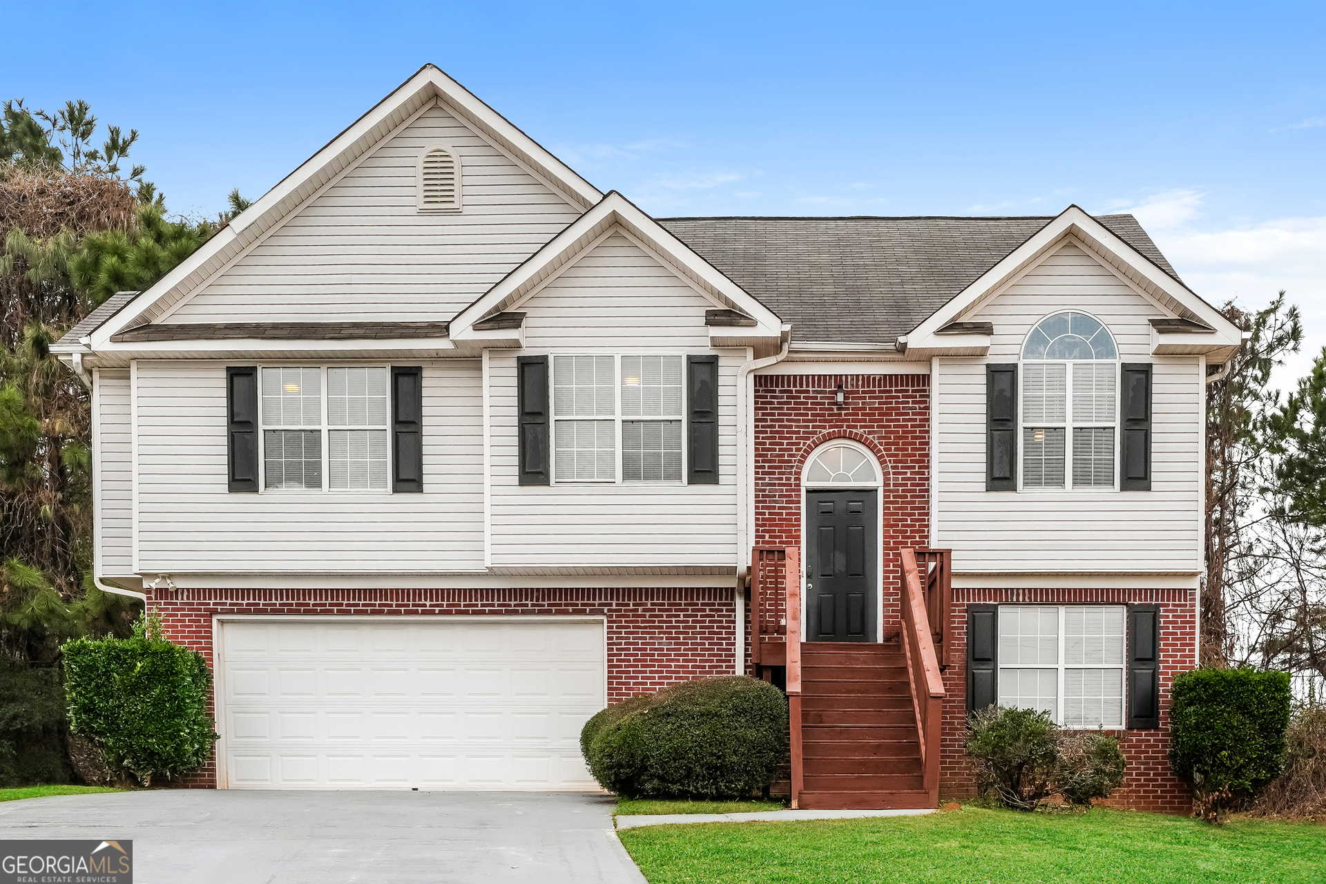 a front view of a house with garden