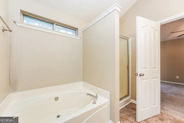 a bathroom with a tub and shower