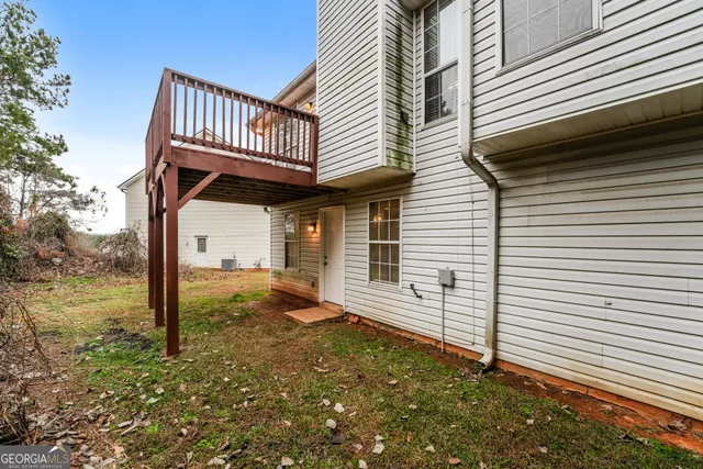 a view of a house with backyard and deck