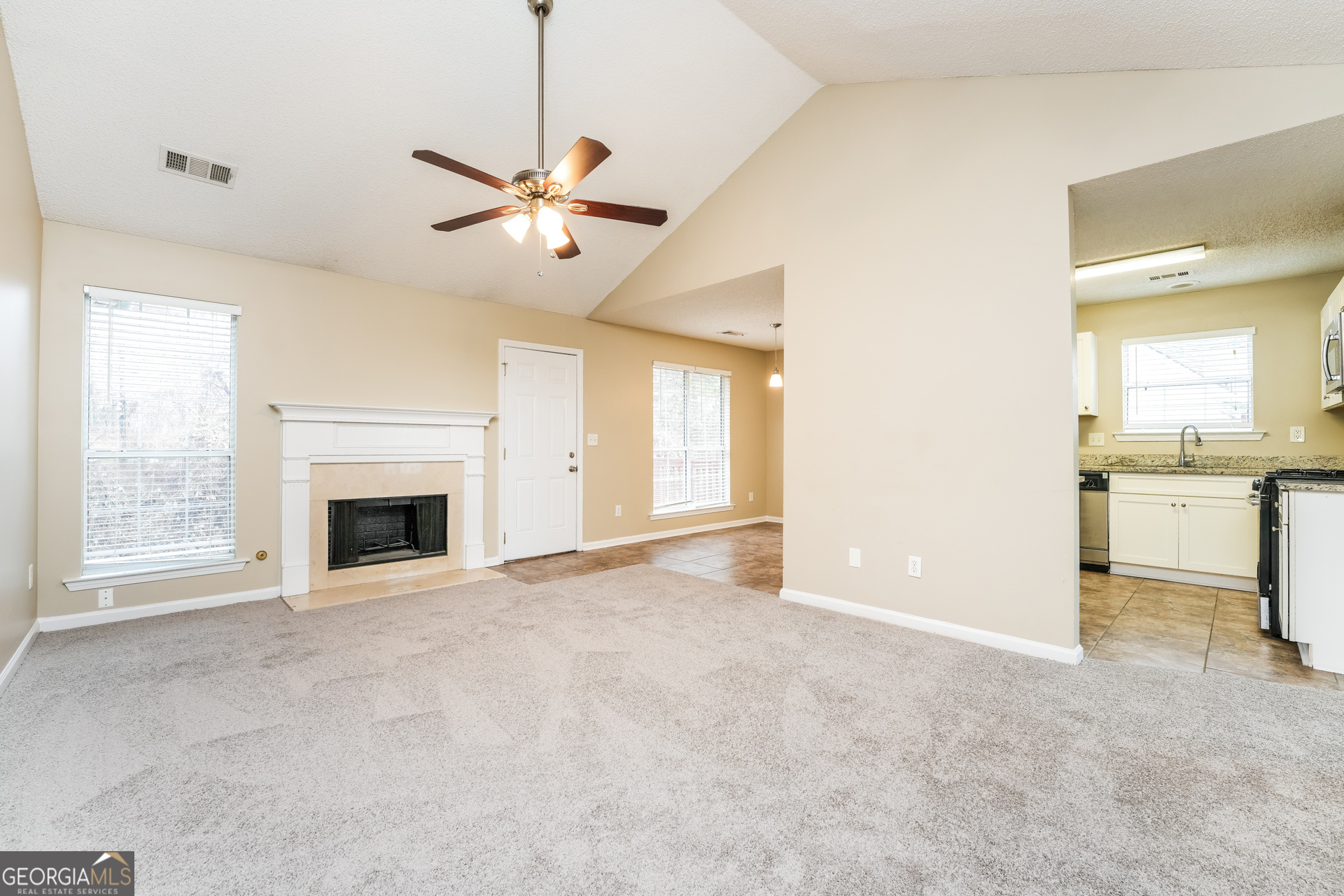 573 Ransom Way Stockbridge, GA 30281 - Photo 2 of 17 a view of a livingroom with a fireplace and a ceiling fan