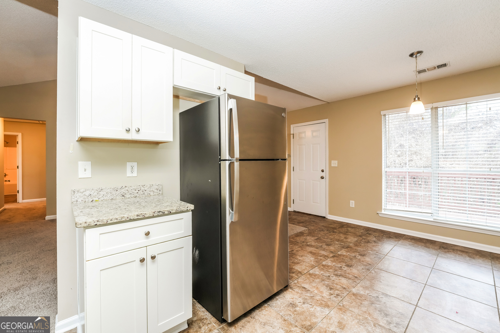 573 Ransom Way Stockbridge, GA 30281 - Photo 6 of 17 a kitchen with stainless steel appliances granite countertop a refrigerator and a sink