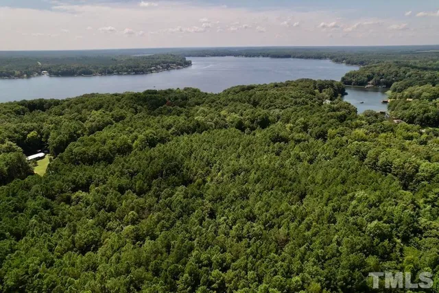 an aerial view of a houses with a lake view