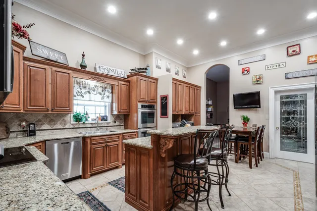 a large kitchen with lots of counter space and dining table