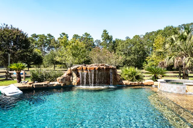 a view of a backyard with lawn chairs and a fire pit