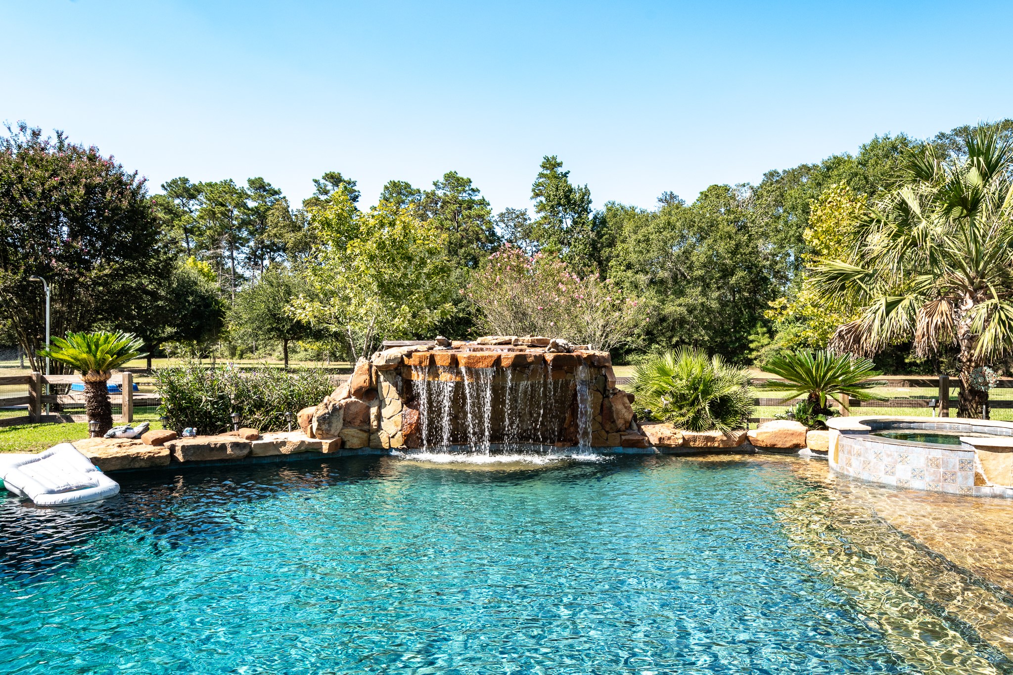 11105 Crockett Martin Road Conroe, TX 77306 - Photo 24 of 35 a view of a backyard with lawn chairs and a fire pit