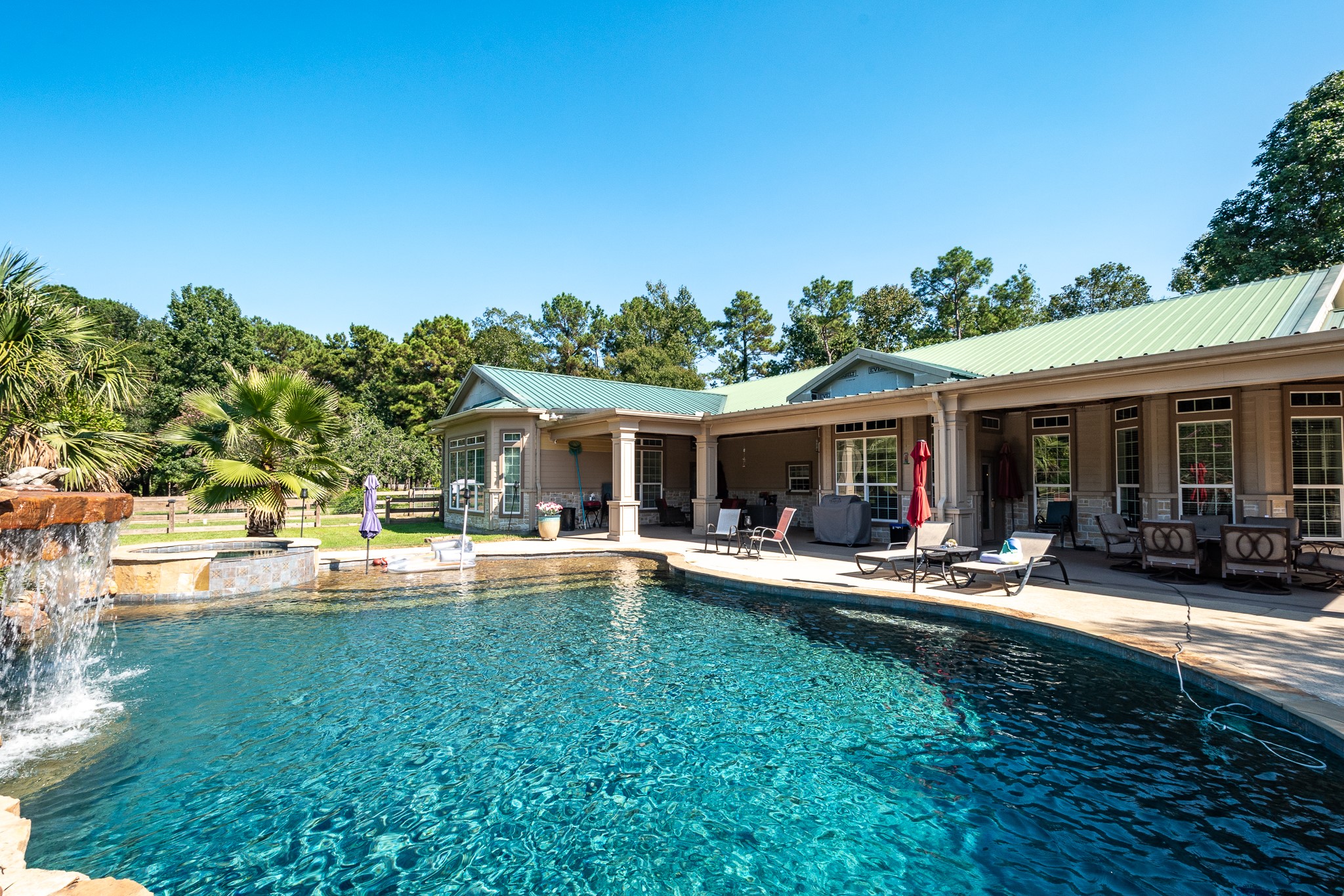 11105 Crockett Martin Road Conroe, TX 77306 - Photo 25 of 35 front view of a house with swimming pool and sitting area