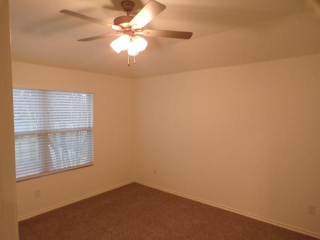 709 South 5th Street, Unit 1 Bonham, TX 75418 - Photo 15 of 32 an empty room with a window and a fan
