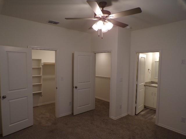 709 South 5th Street, Unit 1 Bonham, TX 75418 - Photo 17 of 32 an empty room with closet and a ceiling fan