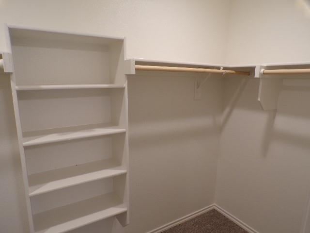 709 South 5th Street, Unit 1 Bonham, TX 75418 - Photo 18 of 32 a view of walk in closet with empty racks