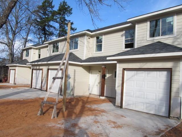 709 South 5th Street, Unit 1 Bonham, TX 75418 - Photo 2 of 32 a front view of a house with a garage