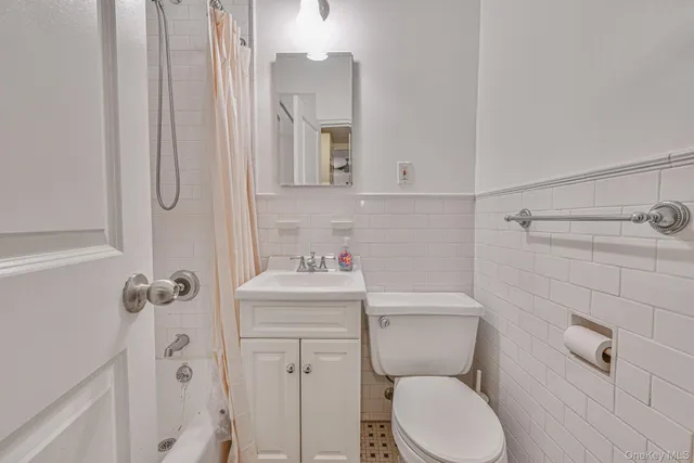 a bathroom with a toilet sink shower and mirror