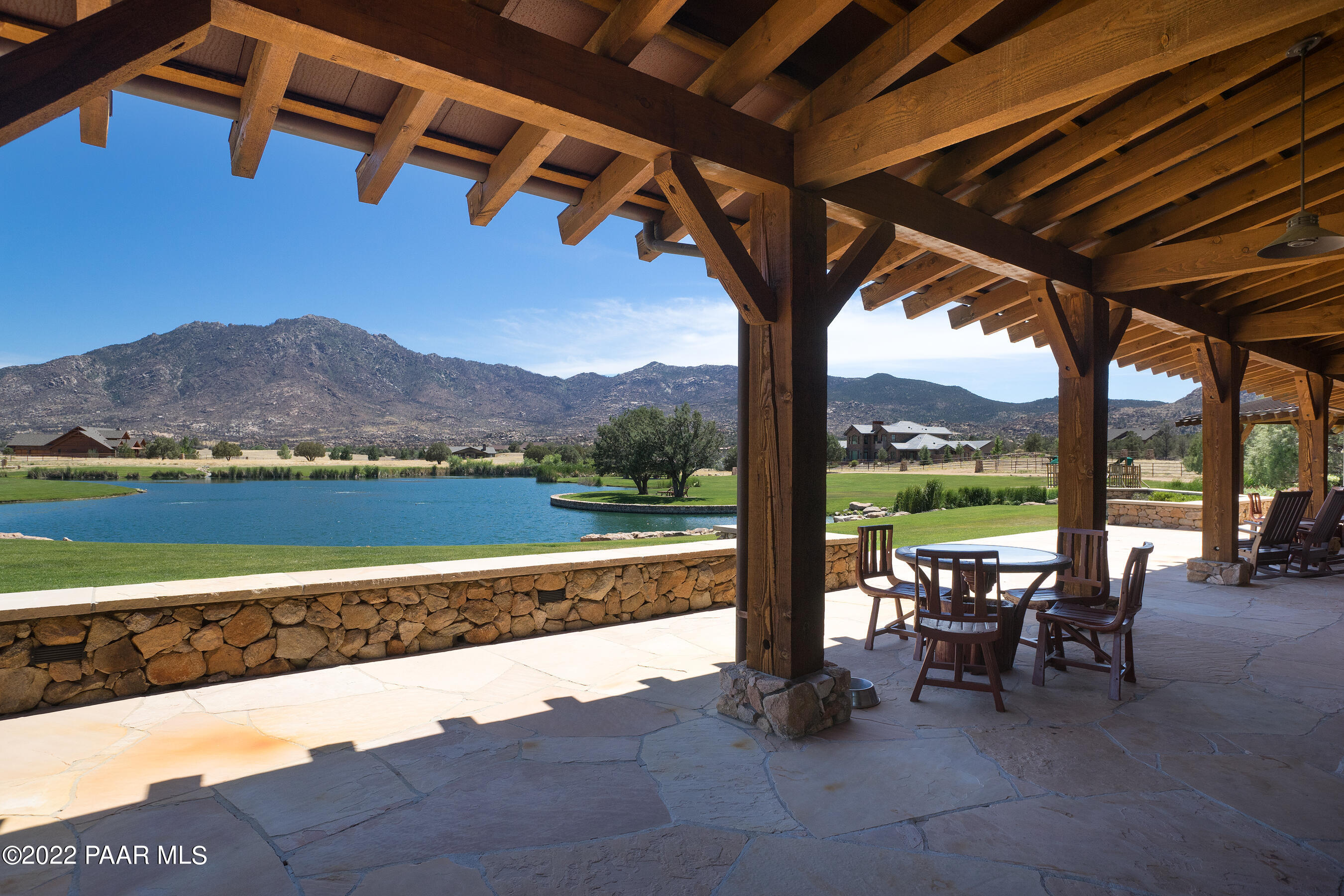 9630 North Equine Road Prescott, AZ 86305 - Photo 26 of 28 a view of a swimming pool with a table and chairs under an umbrella