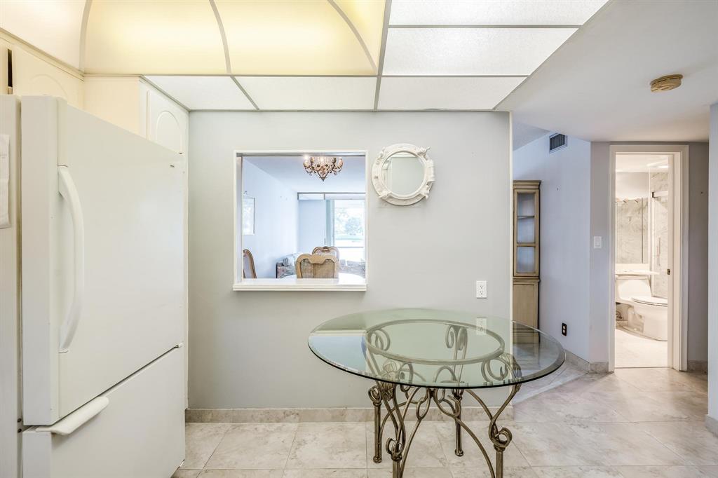 9500 North Hollybrook Lake Drive, Unit 109 Pembroke Pines, FL 33025 - Photo 12 of 57 a view of a dining room with a table and chairs