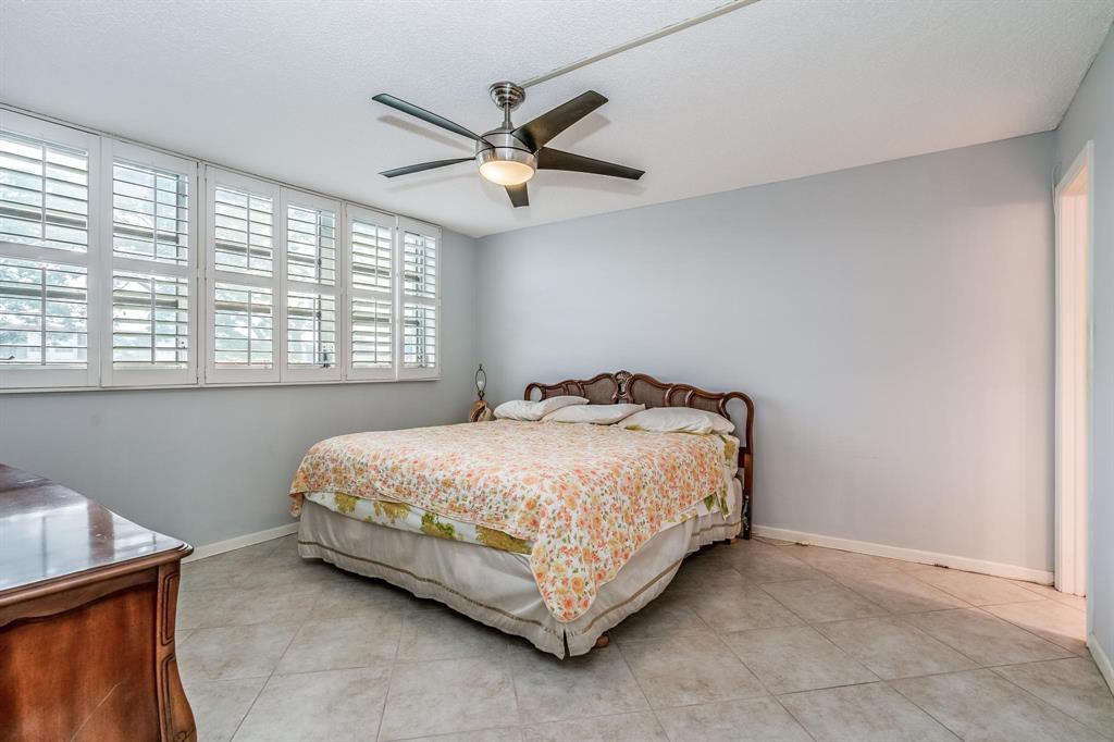 9500 North Hollybrook Lake Drive, Unit 109 Pembroke Pines, FL 33025 - Photo 16 of 57 a bed sitting in a room next to a window