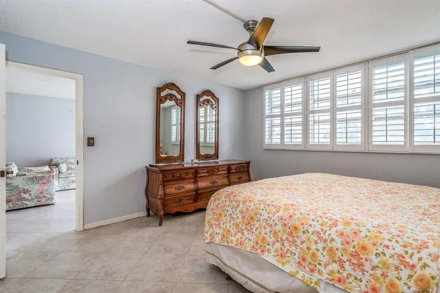 a view of a bedroom with a bed and chair