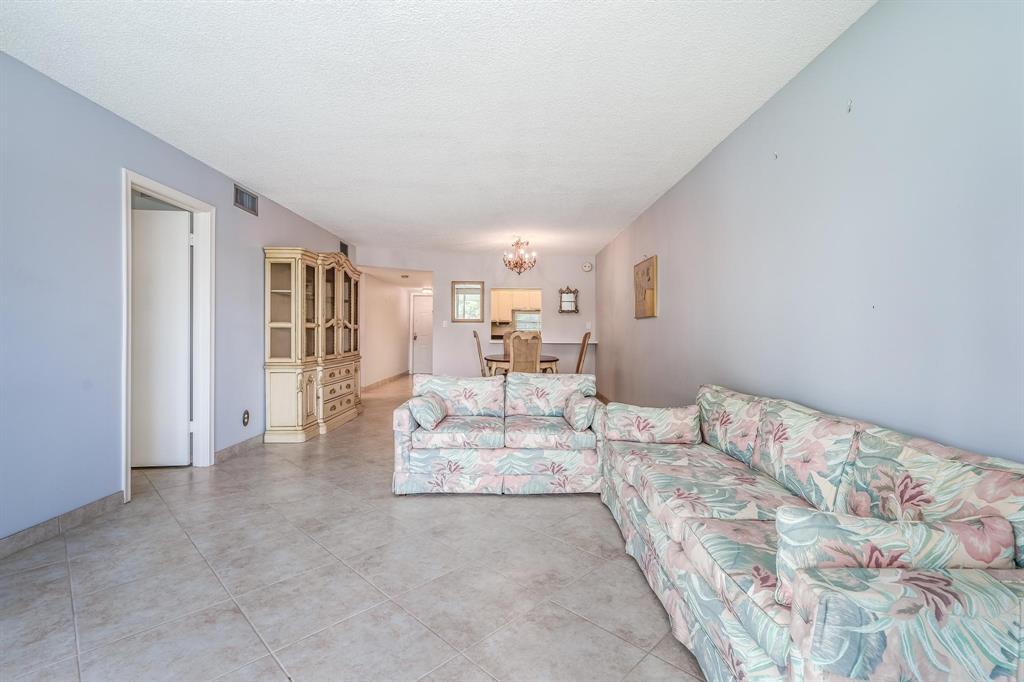 9500 North Hollybrook Lake Drive, Unit 109 Pembroke Pines, FL 33025 - Photo 18 of 57 a view of a bedroom with a bed and chair