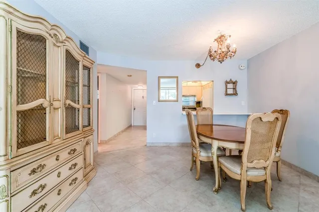 a kitchen with stainless steel appliances a refrigerator and white cabinets
