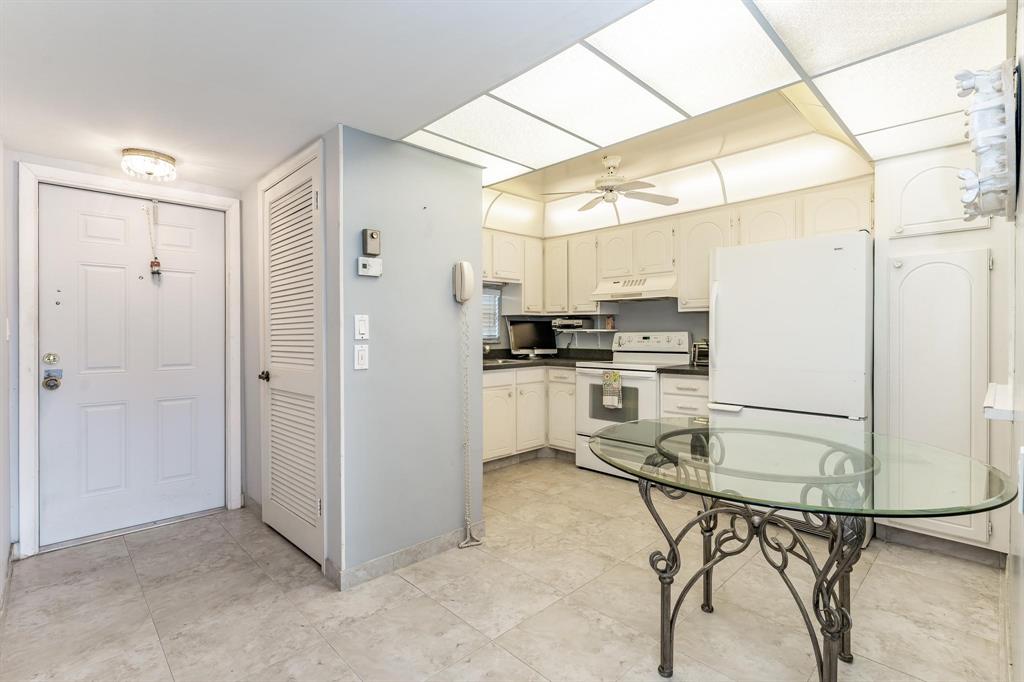 9500 North Hollybrook Lake Drive, Unit 109 Pembroke Pines, FL 33025 - Photo 20 of 57 a kitchen with stainless steel appliances a refrigerator and white cabinets