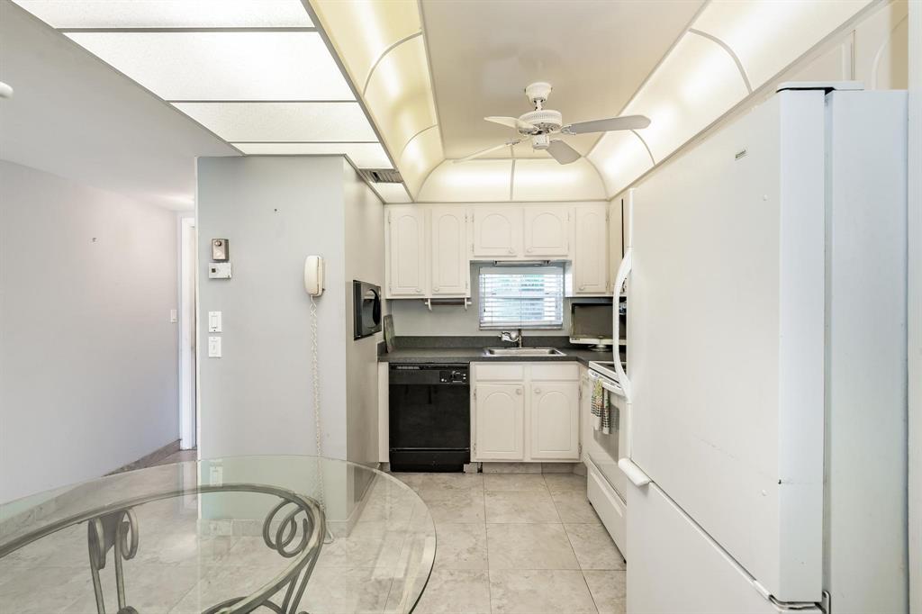 9500 North Hollybrook Lake Drive, Unit 109 Pembroke Pines, FL 33025 - Photo 21 of 57 a kitchen with stainless steel appliances granite countertop a stove a refrigerator and a microwave