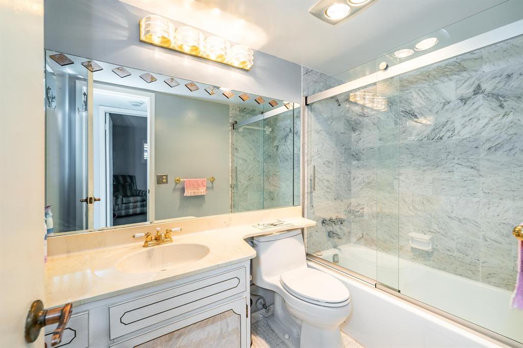 9500 North Hollybrook Lake Drive, Unit 109 Pembroke Pines, FL 33025 - Photo 4 of 57 a bathroom with a sink a toilet and a mirror