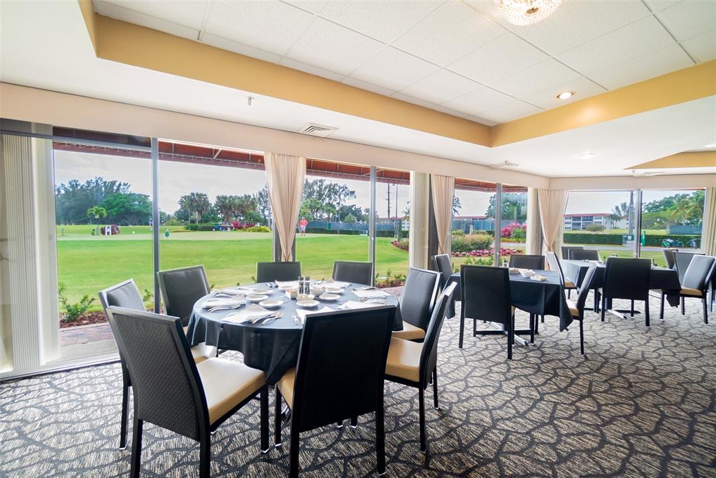 9500 North Hollybrook Lake Drive, Unit 109 Pembroke Pines, FL 33025 - Photo 45 of 57 a dining room with furniture outdoor view and a garden