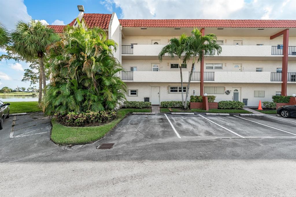 9500 North Hollybrook Lake Drive, Unit 109 Pembroke Pines, FL 33025 - Photo 9 of 57 a front view of a house with garden