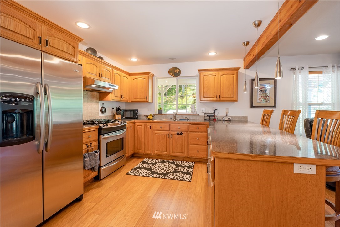 9080 Kendall Road Sumas, WA 98295 - Photo 4 of 39 a kitchen with stainless steel appliances granite countertop a sink a stove and a refrigerator