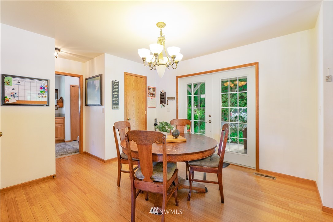 9080 Kendall Road Sumas, WA 98295 - Photo 7 of 39 a view of a dining room with furniture a chandelier and wooden floor