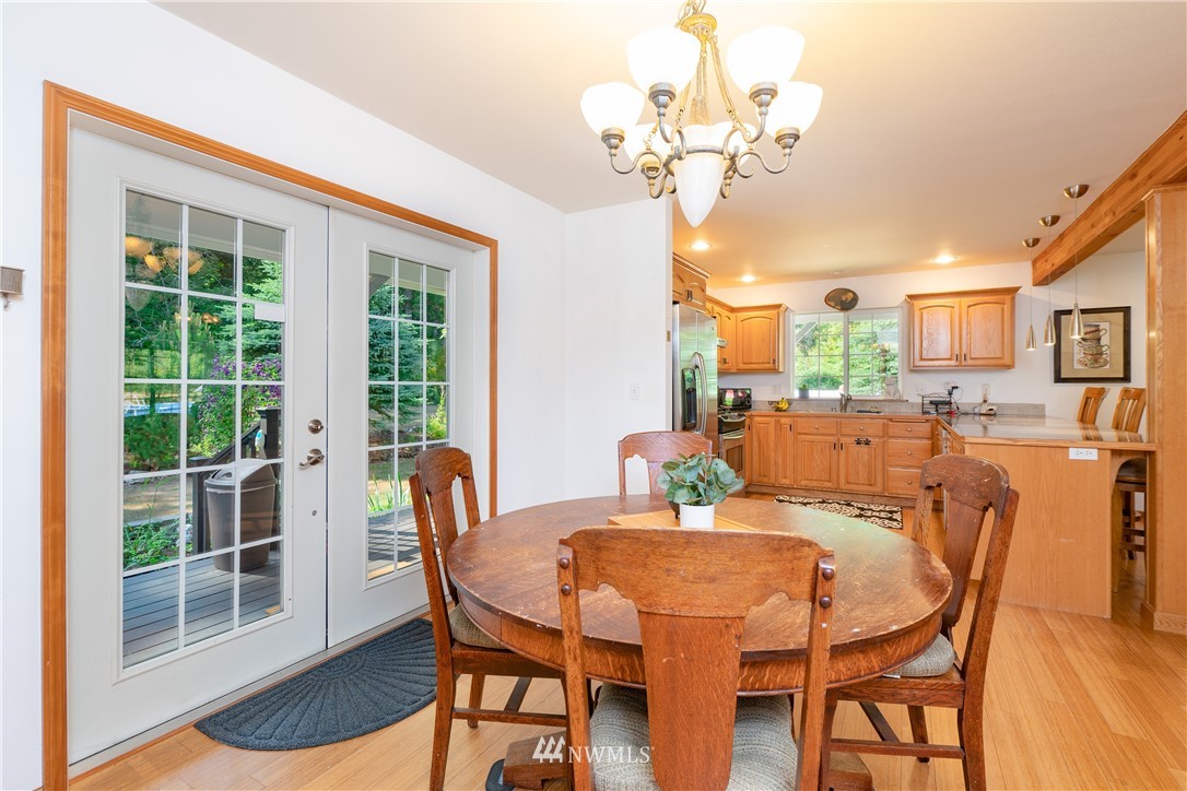 9080 Kendall Road Sumas, WA 98295 - Photo 8 of 39 a view of a dining room with furniture a chandelier and wooden floor
