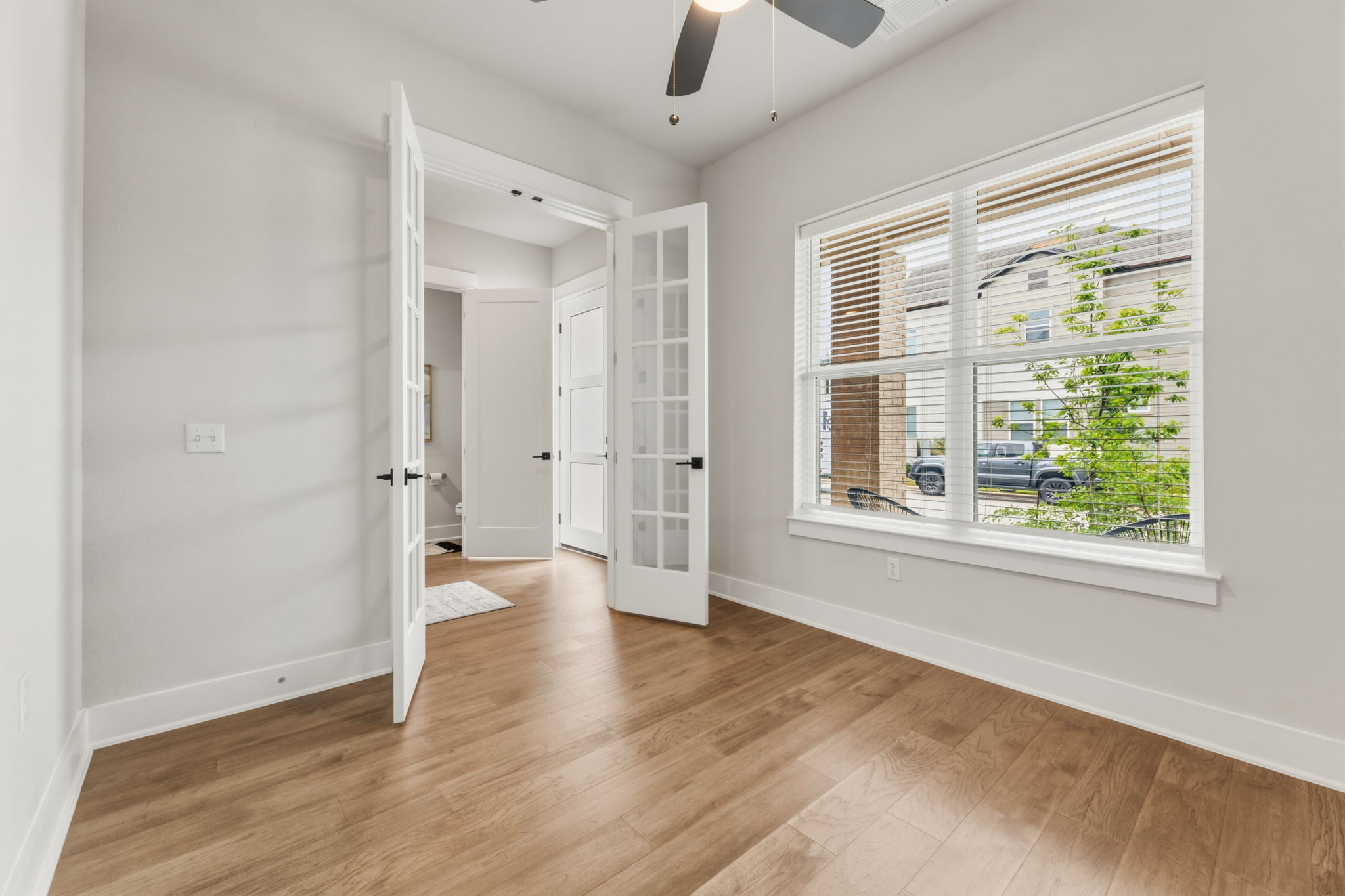2929 Moreno Street Austin, TX 78723 - Photo 5 of 40 Room featuring wood-finish flooring, light grey wall paint, and white trim