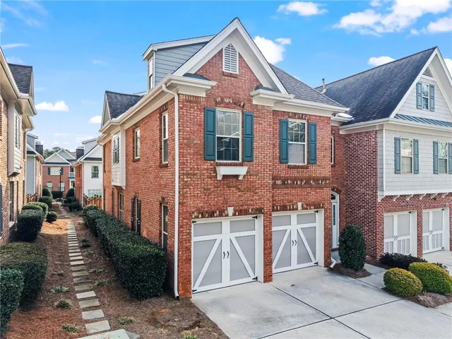 a view of a brick house with many windows