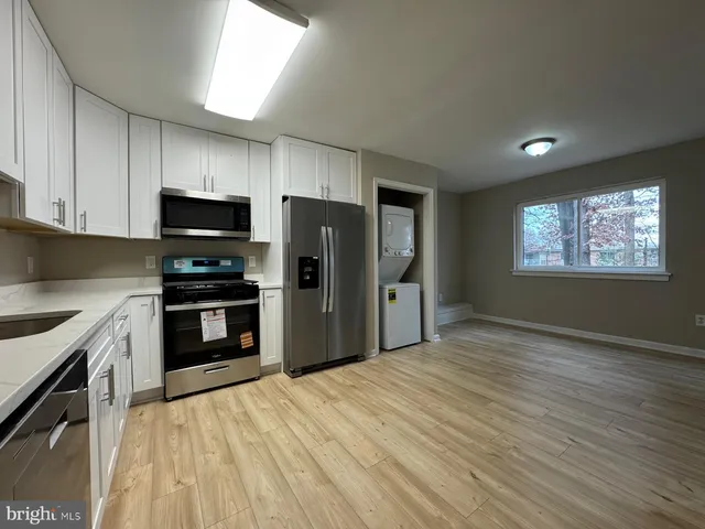 a kitchen with stainless steel appliances granite countertop a refrigerator stove and sink