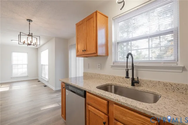 a kitchen with sink cabinets and wooden floor