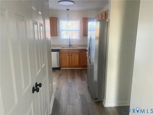 a bathroom with a sink a toilet a mirror and window