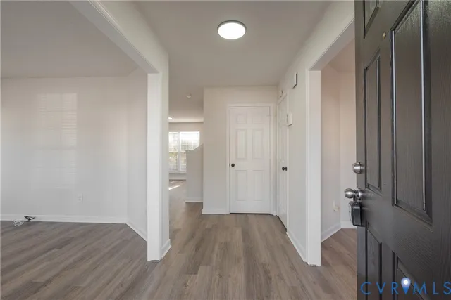 a view of a room with wooden floor