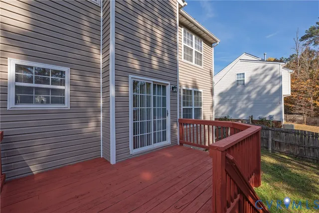 a view of deck with two chairs and wooden fence