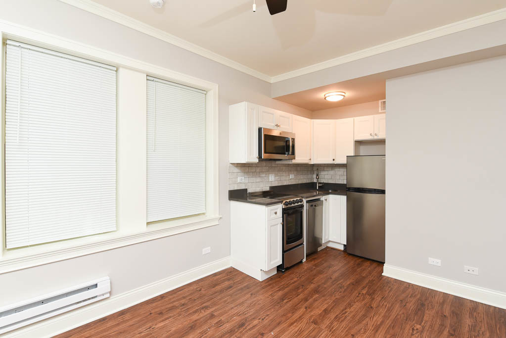 640 West Wrightwood Avenue, Unit 106 Chicago, IL 60614 - Photo 11 of 15 a kitchen with stainless steel appliances granite countertop a stove a sink and a refrigerator