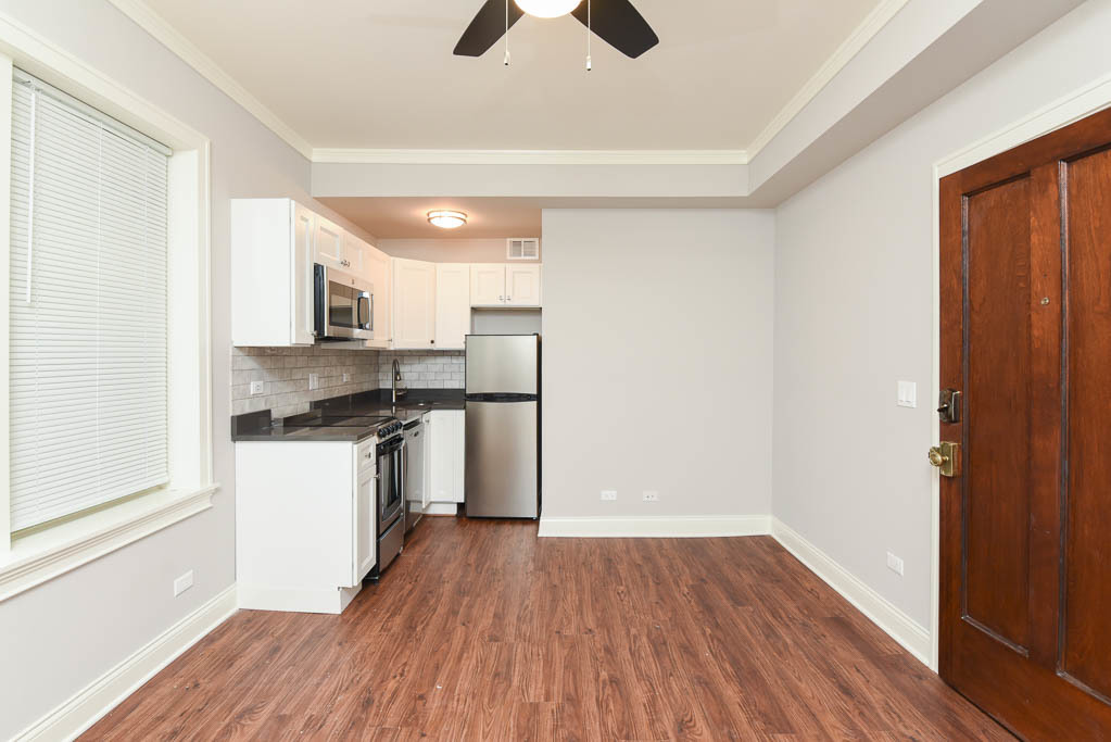 640 West Wrightwood Avenue, Unit 106 Chicago, IL 60614 - Photo 10 of 15 a kitchen with a refrigerator and white cabinets